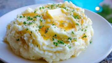 Close-up of smooth, velvety super creamy mashed potatoes showing rich texture and buttery swirl.