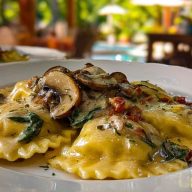 Creamy mushroom ravioli topped with sliced mushrooms and herbs, served in a white bowl on a cozy outdoor dining table.