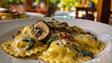 Creamy mushroom ravioli topped with sliced mushrooms and herbs, served in a white bowl on a cozy outdoor dining table.