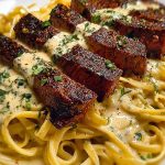 Cajun Garlic Butter Steak over Creamy Parmesan Linguine